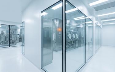 Cleanroom corridor with glass-walled process rooms (AI-generated illustration)
